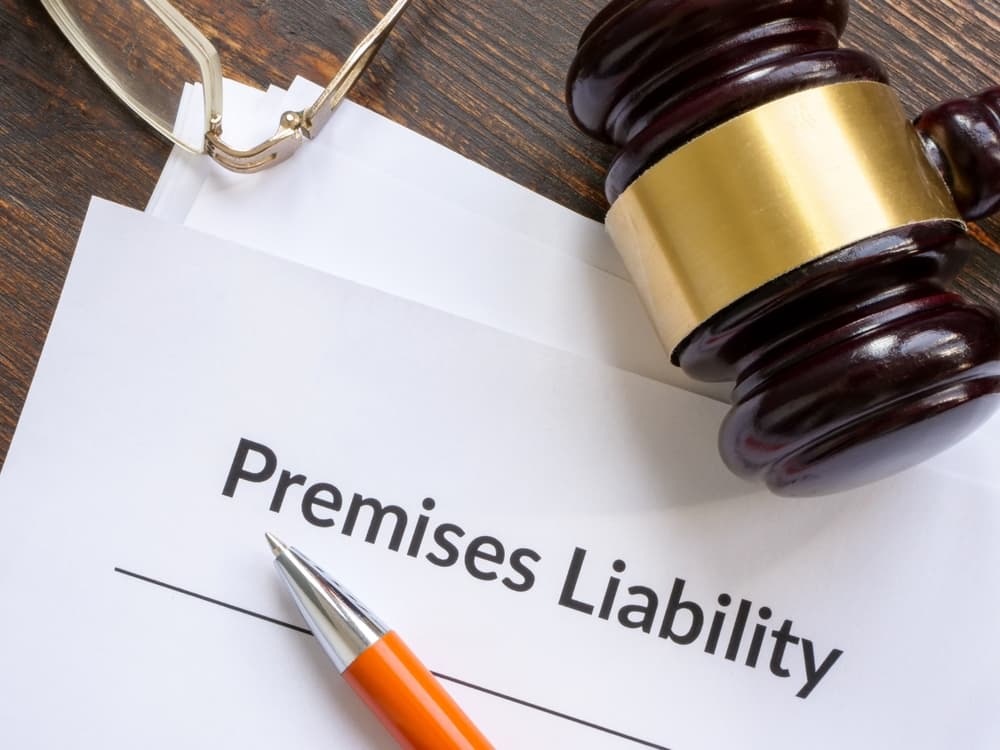 Documents about premises liability and Pennsylvania slip and fall laws with gravel and the pen.