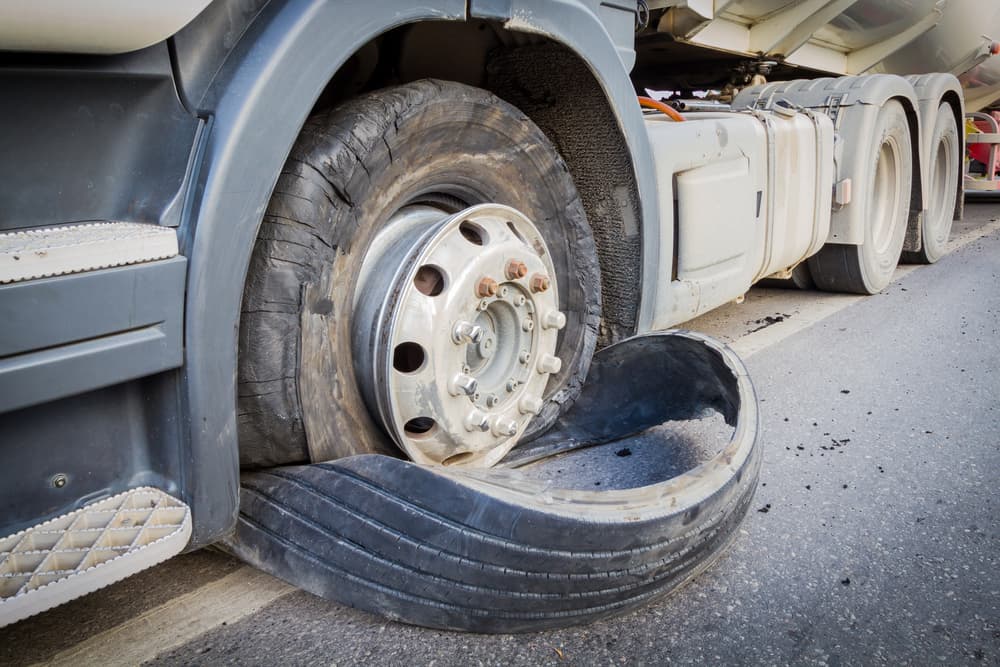 Damaged 18-Wheeler Semi Truck with Burst Tires Close-up on the Highway.