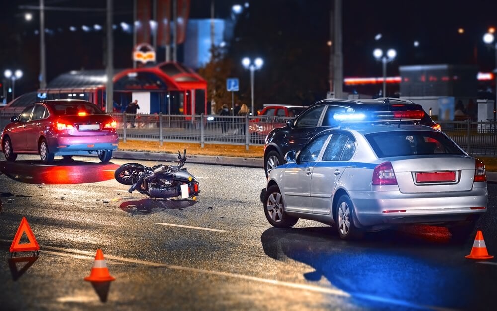 A motorcycle lies on the road post-accident, highlighting the need for legal assistance from a motorcycle accident lawyer