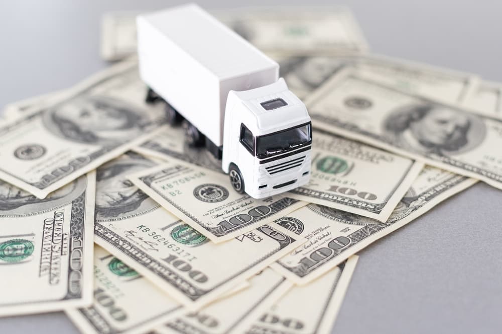 A truck miniature on dollars