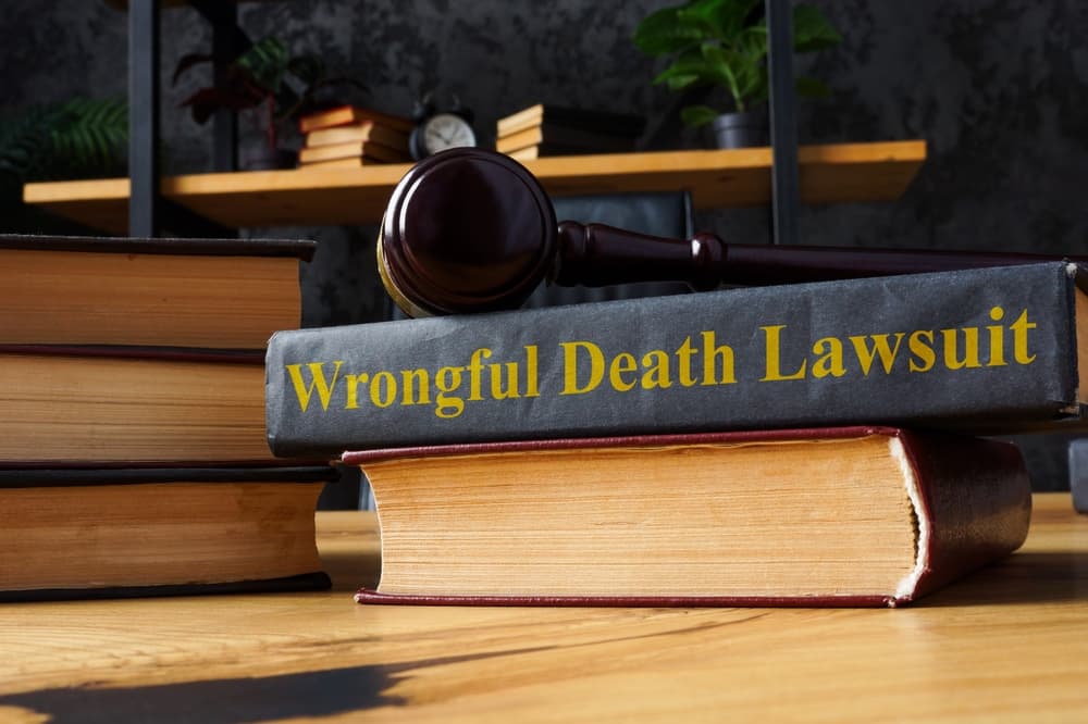 Wrongful Death Lawsuit-Pile of Books and Gavel over there